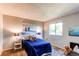 Cozy bedroom features carpet floors, side tables with lamps and bright window views at 8538 W Glasgow Pl, Littleton, CO 80128