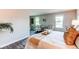 Bright bedroom featuring a sitting area, wood floors and large bed with decorative pillows and blanket at 8538 W Glasgow Pl, Littleton, CO 80128