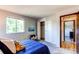 This cozy bedroom features carpet floors, closet, bright window and comfy bedding at 8538 W Glasgow Pl, Littleton, CO 80128