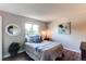 Comfortable bedroom with a large window, modern flooring and cool blue decor at 8538 W Glasgow Pl, Littleton, CO 80128