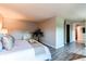 Bright bedroom featuring wood floors, a large bed topped with throw blanket and side table decorations at 8538 W Glasgow Pl, Littleton, CO 80128