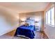 Cozy bedroom featuring a bright blue bed and an ocean themed wall art at 8538 W Glasgow Pl, Littleton, CO 80128
