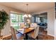 Bright dining area with seating for four, large window, and wood-look flooring at 8538 W Glasgow Pl, Littleton, CO 80128