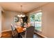 Classic dining room with natural light, wood flooring and a chandelier at 8538 W Glasgow Pl, Littleton, CO 80128