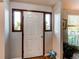 Bright entryway featuring hardwood floors and sidelight windows at 8538 W Glasgow Pl, Littleton, CO 80128