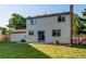 Back exterior view showcasing a well-maintained yard, neutral siding, and cozy outdoor space at 8538 W Glasgow Pl, Littleton, CO 80128