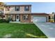 Traditional home with brick and vinyl siding and a freshly cut lawn at 8538 W Glasgow Pl, Littleton, CO 80128