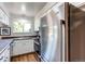 The kitchen features stainless steel appliances, bright white cabinets, and a large window at 8538 W Glasgow Pl, Littleton, CO 80128