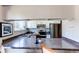 Kitchen features white cabinets, laminate counters, and stainless steel appliances at 8538 W Glasgow Pl, Littleton, CO 80128