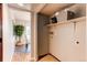 Functional laundry room with storage shelves, offering convenience and organization at 8538 W Glasgow Pl, Littleton, CO 80128