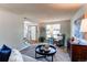 Comfortable living room featuring carpet flooring and a view of the front entrance at 8538 W Glasgow Pl, Littleton, CO 80128