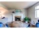 Cozy living room showcasing a fireplace and comfortable seating arrangements at 8538 W Glasgow Pl, Littleton, CO 80128