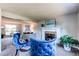 Cozy living room features a brick fireplace, plush seating, and bright, neutral colors at 8538 W Glasgow Pl, Littleton, CO 80128