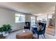 Comfortable living area featuring a carpet and connection to the kitchen at 8538 W Glasgow Pl, Littleton, CO 80128