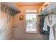Walk-in closet features shelving, hanging rods and a bright window providing natural light at 8538 W Glasgow Pl, Littleton, CO 80128