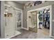Large bathroom features a glass shower, tile floors, laundry closet and open closet at 929 Tenderfoot Dr, Larkspur, CO 80118