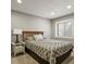 Bedroom with a patterned bedspread, a nightstand and views of the surrounding woods at 929 Tenderfoot Dr, Larkspur, CO 80118