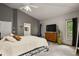 Spacious bedroom with a wrought iron bed frame, neutral carpet, and gray colored walls at 929 Tenderfoot Dr, Larkspur, CO 80118