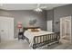 Spacious bedroom with a wrought iron bed frame, neutral carpet, and gray colored walls at 929 Tenderfoot Dr, Larkspur, CO 80118