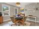 Elegant dining room featuring a round table with seating, contemporary decor, and natural lighting at 929 Tenderfoot Dr, Larkspur, CO 80118
