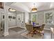 Cozy dining area features a round table with comfortable chairs, natural light, and stylish décor at 929 Tenderfoot Dr, Larkspur, CO 80118