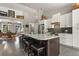 Bright kitchen features stainless steel appliances, subway tile backsplash, and a large island with stool seating at 929 Tenderfoot Dr, Larkspur, CO 80118