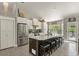 Bright kitchen features stainless steel appliances, subway tile backsplash, and a large island with stool seating at 929 Tenderfoot Dr, Larkspur, CO 80118