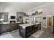 Open concept view from the kitchen to the living room with fireplace at 929 Tenderfoot Dr, Larkspur, CO 80118