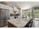 Bright kitchen features stainless steel appliances, subway tile backsplash, and a large island with stool seating at 929 Tenderfoot Dr, Larkspur, CO 80118
