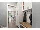 Mudroom featuring storage cabinets, coat hooks, a wood bench and views of the kitchen at 929 Tenderfoot Dr, Larkspur, CO 80118