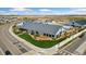 An aerial view showcases a commercial establishment, featuring landscaping and a spacious parking area at 18060 E 106Th Pl, Commerce City, CO 80022