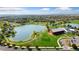 Beautiful aerial view of the community lake, clubhouse, and surrounding neighborhood at 18060 E 106Th Pl, Commerce City, CO 80022