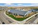 Aerial view of a modern farm style retail space with a large parking lot and landscaping at 18060 E 106Th Pl, Commerce City, CO 80022