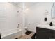 Clean bathroom featuring a shower over bath, stylish vanity, and modern fixtures at 18060 E 106Th Pl, Commerce City, CO 80022