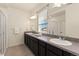 A spacious bathroom offers a double sink vanity, modern lighting, and a walk-in shower at 18060 E 106Th Pl, Commerce City, CO 80022