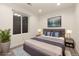Serene bedroom with a large window, soft lighting, and a comfortable bed styled with decorative pillows at 18060 E 106Th Pl, Commerce City, CO 80022