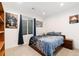 Well-lit bedroom featuring a comfortable bed, window, side table and carpeted floor at 18060 E 106Th Pl, Commerce City, CO 80022