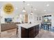 A bright kitchen with an island connects to a living and dining area for easy entertaining at 18060 E 106Th Pl, Commerce City, CO 80022