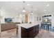 Open-concept kitchen with a center island that seamlessly flows into the dining and living areas at 18060 E 106Th Pl, Commerce City, CO 80022