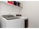 Well-lit laundry room with a Samsung washer and dryer set and shelving for storage at 18060 E 106Th Pl, Commerce City, CO 80022