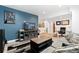 Cozy living room featuring a blue accent wall and a large television, perfect for relaxing at 18060 E 106Th Pl, Commerce City, CO 80022