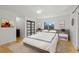 Bright bedroom featuring wood floors, neutral walls, and a sliding-door closet at 6148 Willow Ln, Boulder, CO 80301