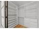 Well-organized walk-in closet featuring custom shelving and three drawers at 6148 Willow Ln, Boulder, CO 80301