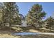 Beautiful backyard view of townhomes with mature trees and lush green grass at 10425 Red Mountain West, Littleton, CO 80127