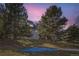 Beautiful backyard view of townhomes with mature trees and colorful sky at 10425 Red Mountain West, Littleton, CO 80127