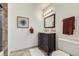 Charming bathroom featuring a vanity with dark wood cabinets, neutral walls, and tile flooring at 10425 Red Mountain West, Littleton, CO 80127