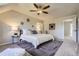 Spacious bedroom with a vaulted ceiling, ceiling fan, neutral decor, and a cozy rug at 10425 Red Mountain West, Littleton, CO 80127