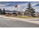 Ken-Caryl Ranch Community Center entrance with an American flag and decorative landscaping at 10425 Red Mountain West, Littleton, CO 80127