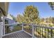 Exterior view of the backyard from a deck, overlooking a green yard with mature trees at 10425 Red Mountain West, Littleton, CO 80127