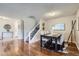 Elegant dining area featuring hardwood floors, staircase, and modern finishes at 10425 Red Mountain West, Littleton, CO 80127